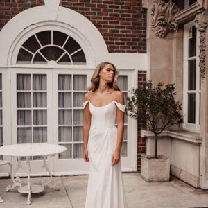 Suzanne Neville Holst Wedding Dress - Fit and flare dress with draped skirt on waist, strapless with off the shoulder delicate sleeves and corset bodice. 