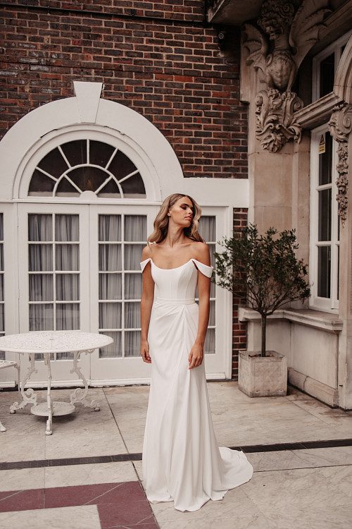 Suzanne Neville Holst Wedding Dress - Fit and flare dress with draped skirt on waist, strapless with off the shoulder delicate sleeves and corset bodice. 