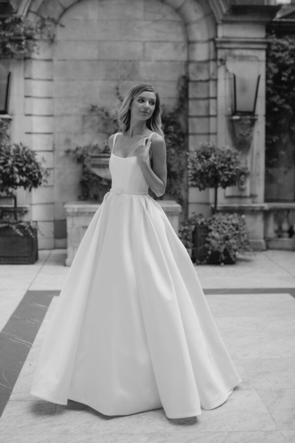 Suzanne Neville Bussotti Wedding Dress - A-Line with interior boning, low square neckline, shoulder straps, a low cut open back and a slim waist belt.