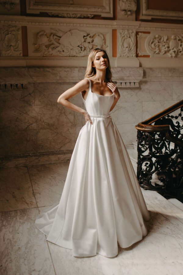 Suzanne Neville Bussotti Wedding Dress - A-Line with interior boning, low square neckline, shoulder straps, a low cut open back and a slim waist belt.