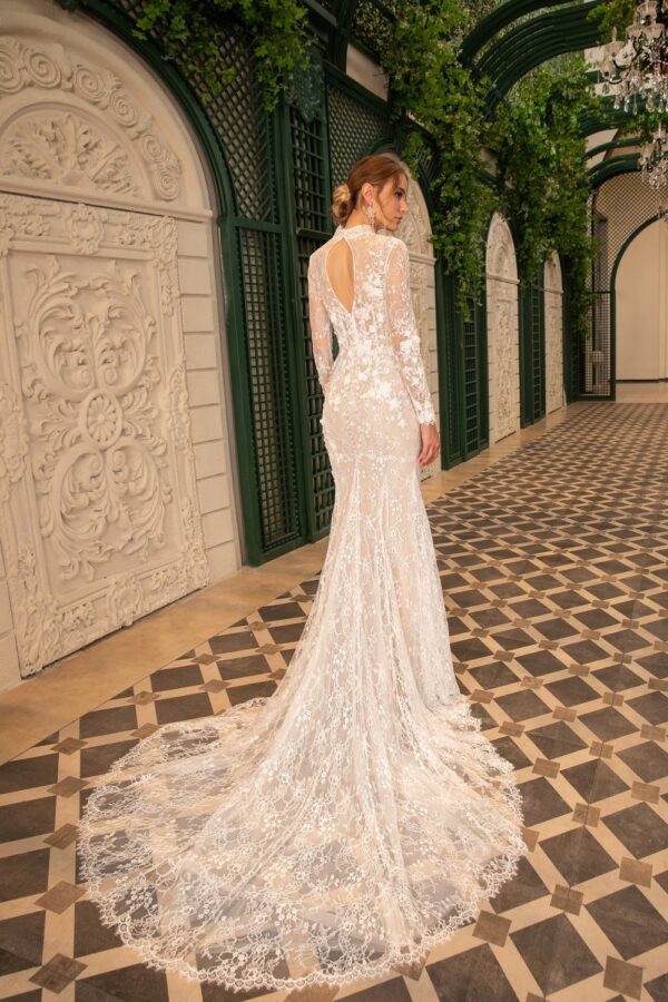 DANY TABET Darryl Wedding Dress - Fit and flare style dress with layered floral laces, high neckline, long sleeves, detailed train and open back detail.