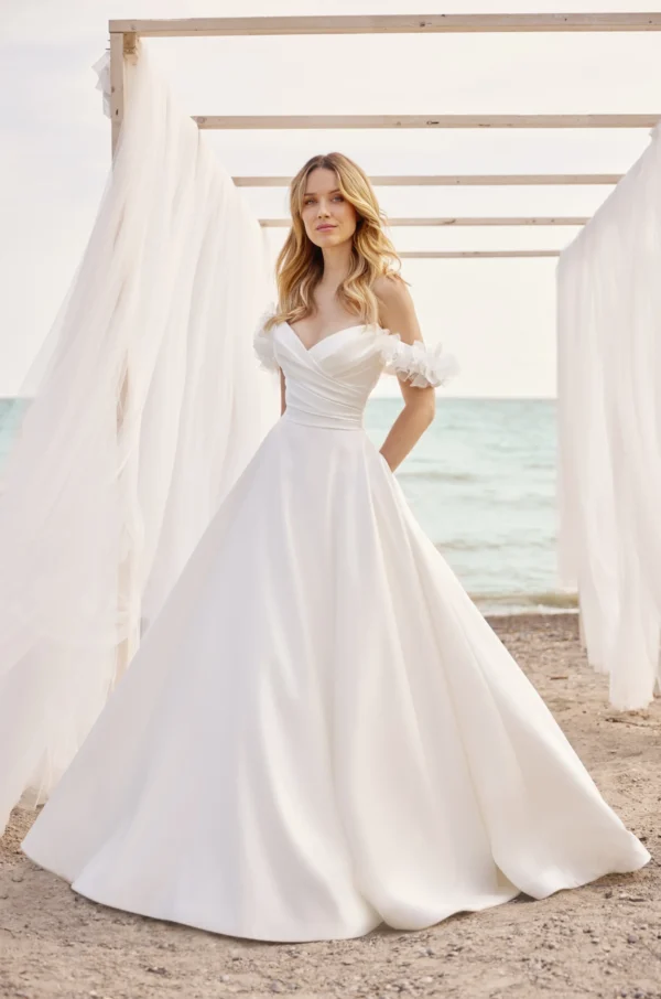 Paloma Blanca 2479 Wedding Dress - Ballgown strapless draped bodice with sweetheart neckline, detachable sleeves with flower detail and skirt with pockets.