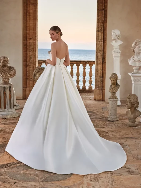 Pronovias Harmonia Wedding Dress - Ballgown with perfect folds of drapery on a classical Greek, detachable ruffle sleeves and cape.
