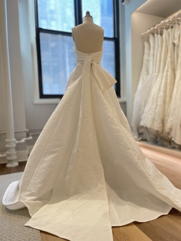 Peter Langner Greta Wedding Dress - Strapless style dress with fit & flare skirt in silk jacquard with draped bodice and asymmetrical back bow.