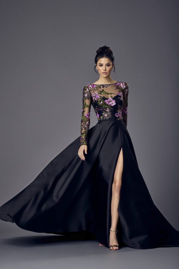 Suzanne Neville Sorelle Wedding Guest Dress - A Line style dress with round neckline, long sleeves, illusion bodice with flower appliqués, and side slit.