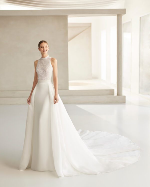 Rosa Clará Barbados Wedding Dress - A-line with removable overskirt, beaded lace embellishment at the waist; halter neckline and round opening on the back.