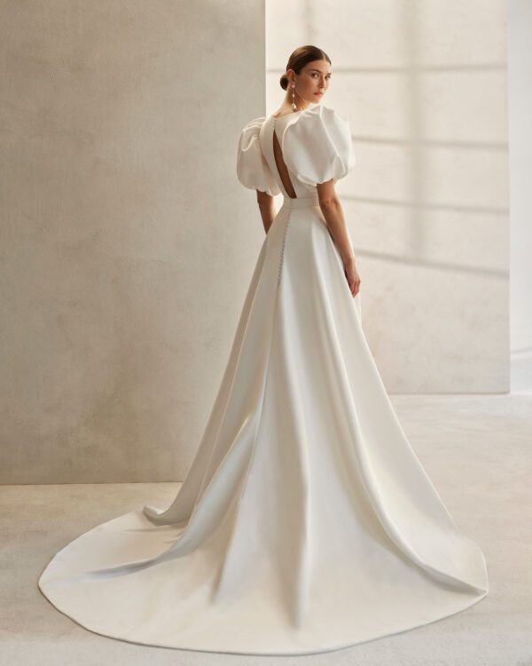 Rosa Clará Fancy Wedding Dress - Short dress with A-Line overskirt, straight side cut and modern style, V-neckline, teardrop back, and puffed sleeves.