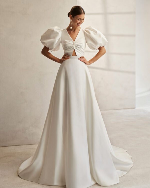 Rosa Clará Fancy Wedding Dress - Short dress with A-Line overskirt, straight side cut and modern style, V-neckline, teardrop back, and puffed sleeves.