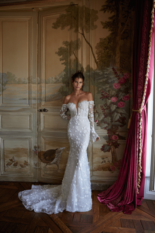 Netta BenShabu Emerson Wedding Dress - Fit and flare style dress with Shiny floral beads appliqués, fitted skirt, long sleeves and deep V-plunging neckline.