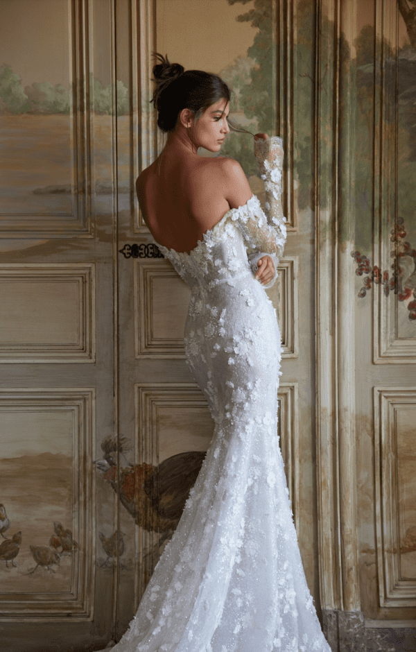 Netta BenShabu Emerson Wedding Dress - Fit and flare style dress with Shiny floral beads appliqués, fitted skirt, long sleeves and deep V-plunging neckline.
