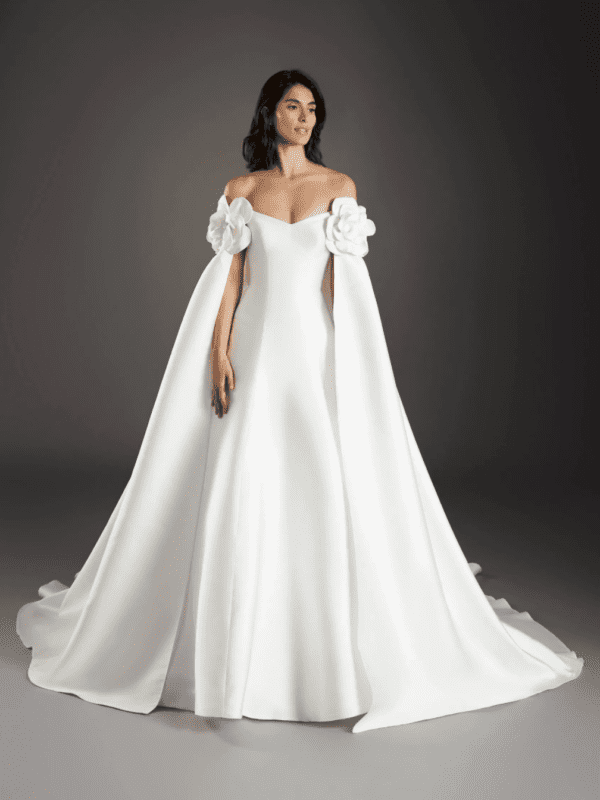 Pronovias Sagrada Wedding Dress - Fit and flare style dress with a strapless v-neckline, open back, covered buttons throughout the skirt and cape.