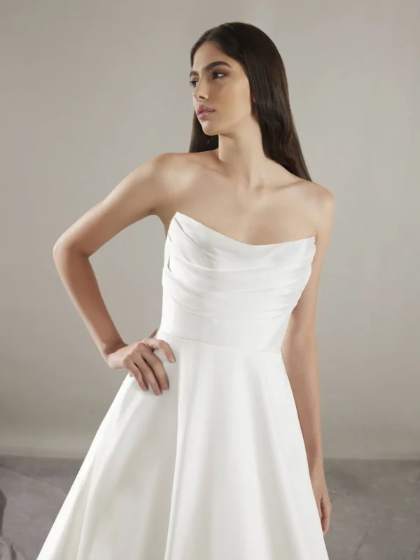 Pronovias Keoni Wedding Dress - Princess-cut with flattering pleats, Mikado fabric, sweetheart neckline, pockets details, wide train and open back.