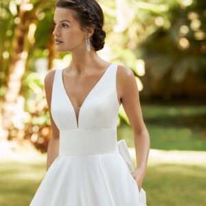 Rosa Clará Zuley Wedding Dress - Classic A-line style dress in satin, deep plunge neckline, U back, fitted bodice, pockets and bow details.