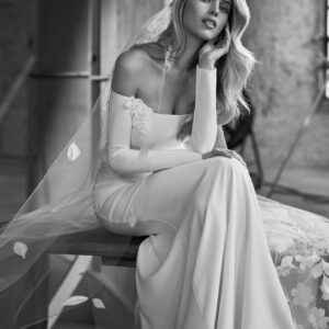 Rosa Clará Whitney Wedding Dress - Elegant and romantic wedding dress crafted in crepe embellished in flower fabric. Off the shoulder neckline and, long sleeves.