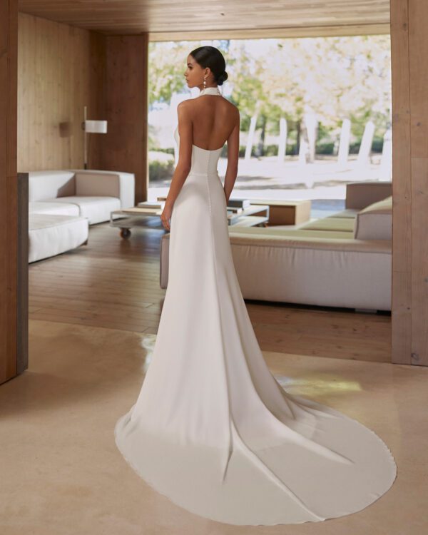 Rosa Clará Abira Wedding Dress - Simple two-piece sheath-style wedding dress, with beadwork details. Featuring a halter neckline and open back with a georgette cape. An on-trend Rosa Clará set.