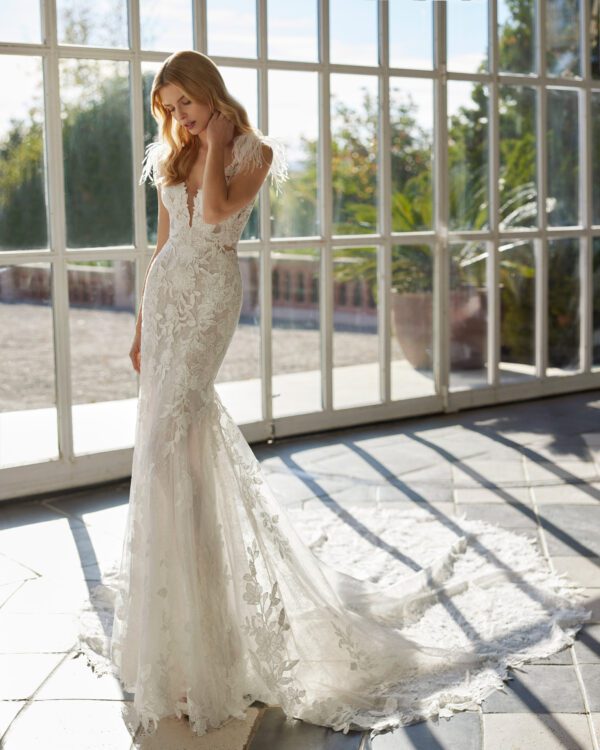 Rosa Clará Vaveri Wedding Dress - Fit and flare style dress with floral beaded lace, deep plunge v neckline, feather on shoulders detail and train. 