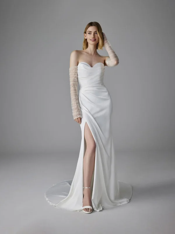 Pronovias Romentina Wedding Dress - Mermaid-Cut dress in satin fabric featuring sleeveless sweetheart neckline, side slit on skirt, and rhinestones details. 