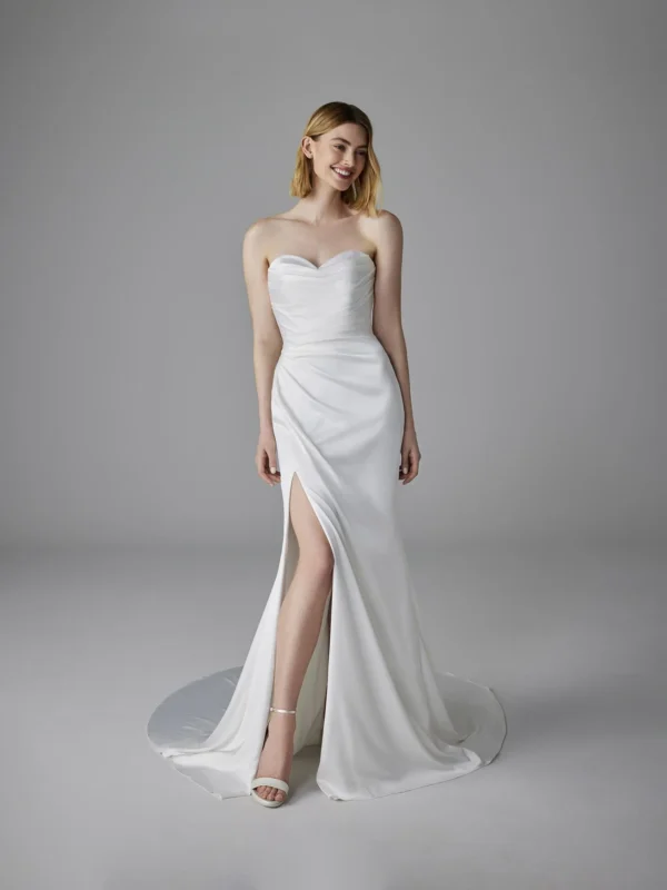 Pronovias Romentina Wedding Dress - Mermaid-Cut dress in satin fabric featuring sleeveless sweetheart neckline, side slit on skirt, and rhinestones details. 