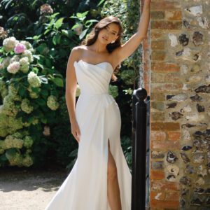 Suzanne Neville Buttercup Wedding Dress - A-line skirt with a side slit, strapless, corseted bodice, sweetheart neckline and asymmetrical detail.