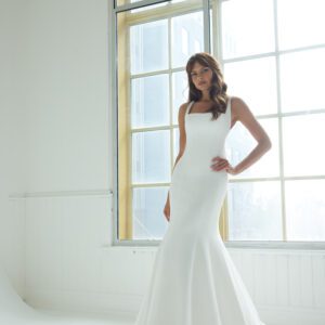 Suzanne Neville Peninsula Wedding Dress - An elegant fit-and-flare gown featuring a modern square neckline, a structured corset bodice, delicate thin straps, and a U-shaped back adorned with covered buttons for a timeless, refined finish.