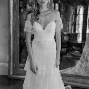 Estee Couture Francine Wedding Dress - A-Line style dress in strapless chantilly lace with tiered skirt, bustier with detachable sleeves, light weight construction, chapel train.