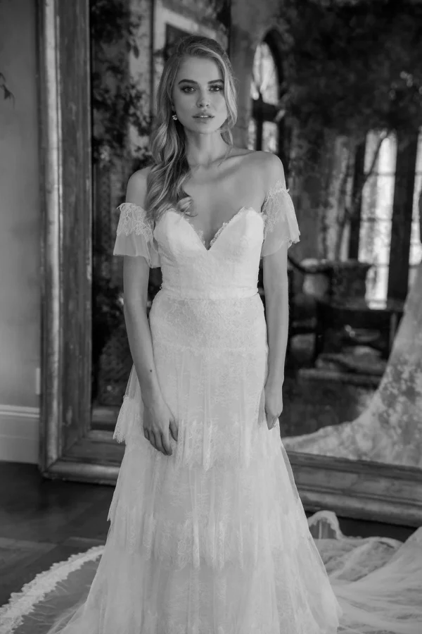 Estee Couture Francine Wedding Dress - A-Line style dress in strapless chantilly lace with tiered skirt, bustier with detachable sleeves, light weight construction, chapel train.