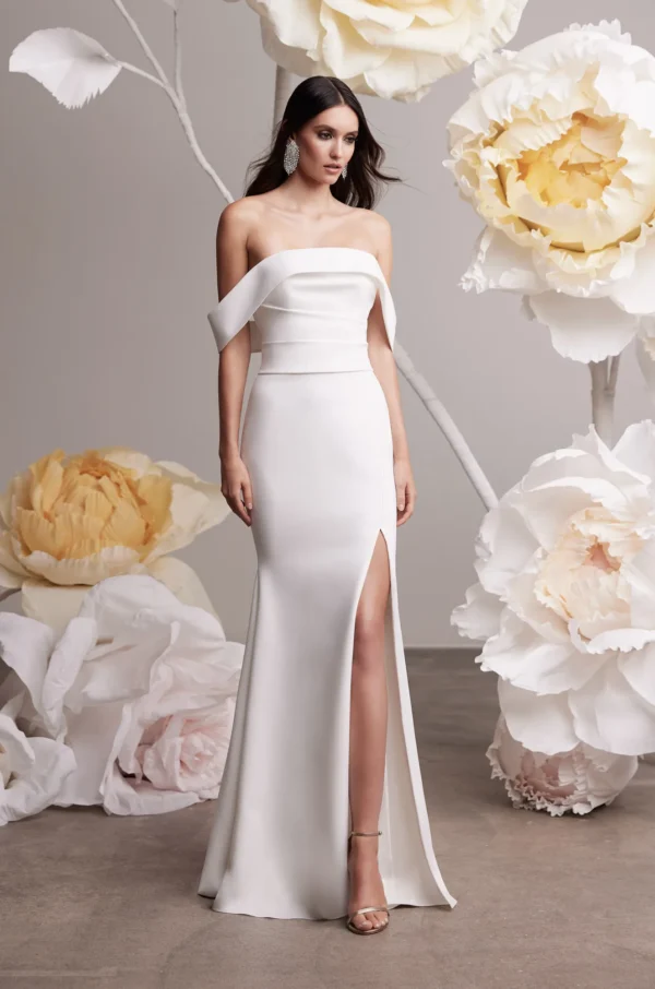 Paloma Blanca 2455 Wedding Dress - Fit and flare style dress with strapless draped bodice, fabric-covered buttons, Crepe skirt, and side slit.