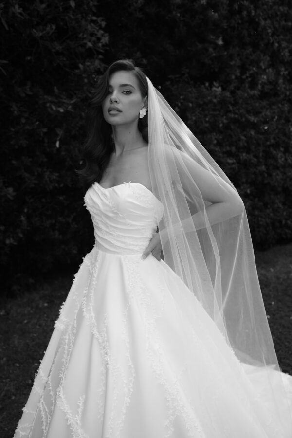 Strapless sweetheart neckline, asymmetrical fitted bodice, and 3D all over details.