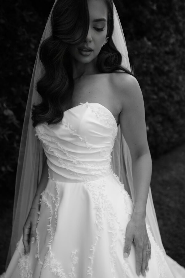 Strapless sweetheart neckline, asymmetrical fitted bodice, and 3D all over details.