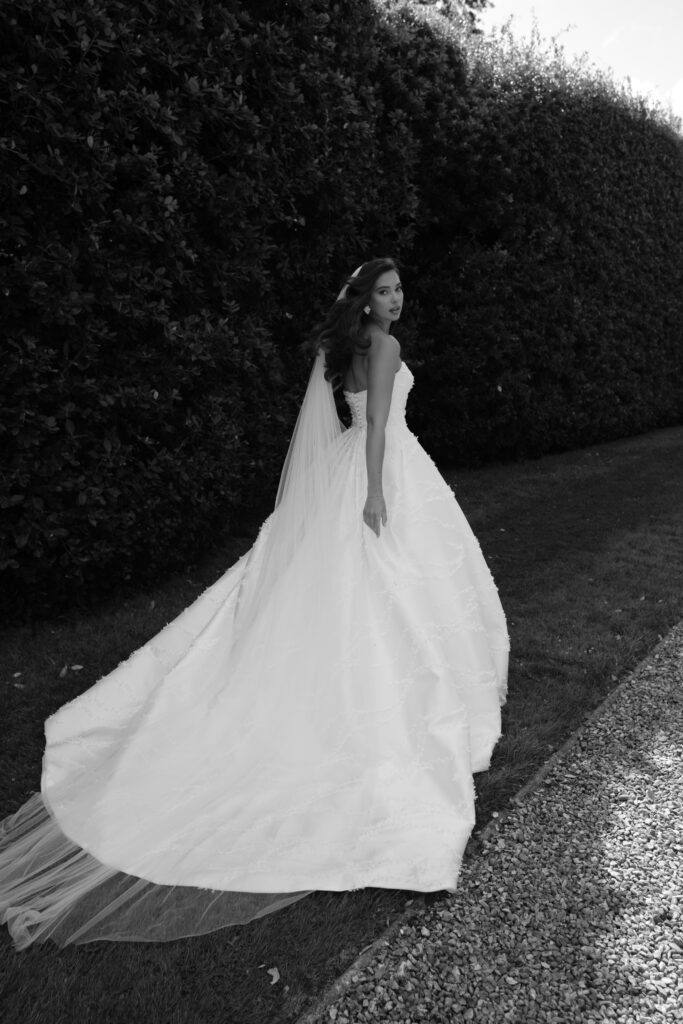 Suzanne Neville Mystique Wedding Dress - Strapless sweetheart neckline, asymmetrical fitted bodice, and 3D all over details.