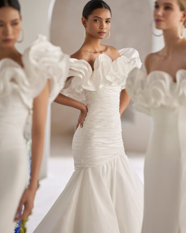 Rosa Clará Tanger Wedding Dress - Sexy mermaid wedding dress made in taffeta. Featuring a strapless neckline, flounced details and a draped bodice.