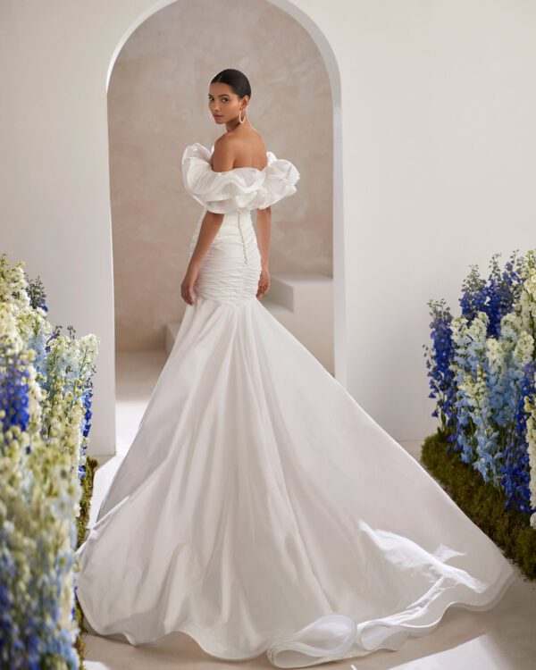 Rosa Clará Tanger Wedding Dress - Sexy mermaid wedding dress made in taffeta. Featuring a strapless neckline, flounced details and a draped bodice.