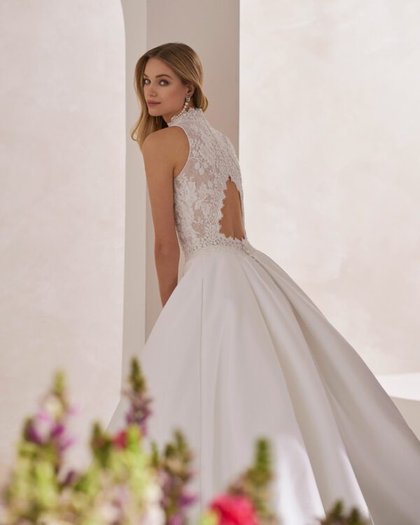 Rosa Clará Tibor Wedding Dress - Classic princess wedding dress made with French jewelled lace and Lira mikado. Showcase a halter neckline, keyhole back and skirt with pockets.