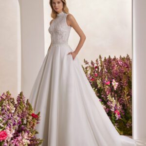 Rosa Clará Tibor Wedding Dress - Classic princess wedding dress made with French jewelled lace and Lira mikado. Showcase a halter neckline, keyhole back and skirt with pockets.