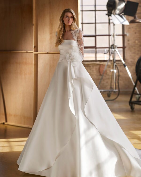Rosa Clará Walezia Wedding Dress - Classic long two-piece ballgown-style wedding dress, made in magnolia mikado and rebrodé lace. Featuring a strapless neckline, plain, voluminous skirt, and jacket in rebrodé lace.