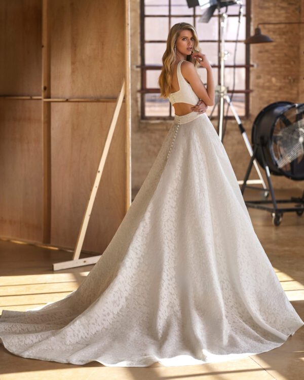 Rosa Clará Wira Wedding Dress - Youthful ballgown-style wedding dress made in fil coupé. A sleeveless design featuring a plunging neckline, square back and cut-out embellishment.