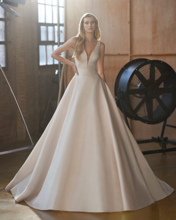 Rosa Clará Wira Wedding Dress - Youthful ballgown-style wedding dress made in fil coupé. A sleeveless design featuring a plunging neckline, square back and cut-out embellishment.