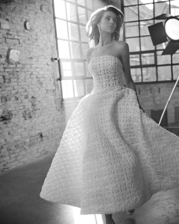 Rosa Clará Wyllow Wedding Dress - Modern midi A-line dress made in embroidered lace. Featuring a strapless neckline, zip back and a skirt with pockets.