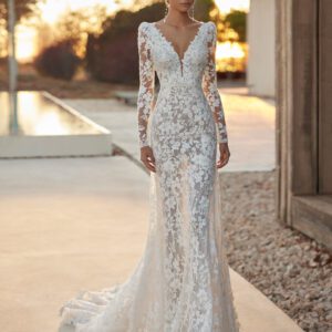 Rosa Clará Amado Wedding Dress - Sheath-style dress in lace and beadwork. The plunging neckline, V-back and long sleeves complete the look.