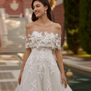 Rosa Clará Iza Wedding Dress - Long romantic princess wedding dress, crafted in lace with a snow tulle skirt. Featuring a sweetheart neckline, buttoned back, detachable sleeves and detachable off-shoulder cuff neckline.