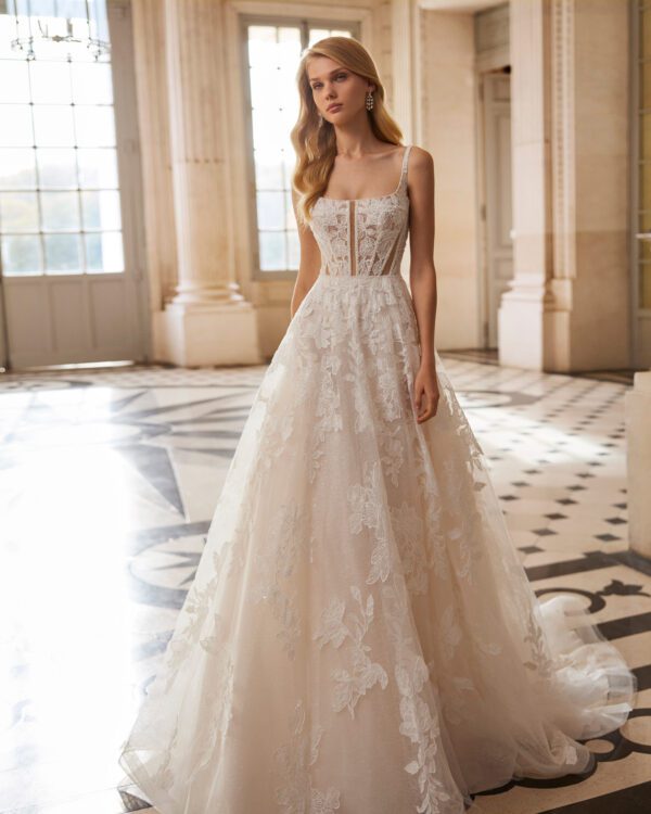 Rosa Clará Ember Wedding Dress - Long A-line princess wedding dress, made in lace with a tulle skirt. Featuring a square neckline, plunging back with beadwork straps and skirt in floral lace with glitter tulle.