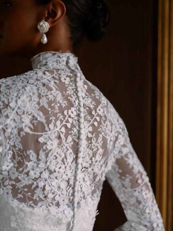 Sareh Nouri Maryanne Wedding Dress - Italian Magnolia straight edge neckline slim flare gown with seamwork detail. Shown with detachable 3D embroidered ¾ length bolero with chantilly trim.