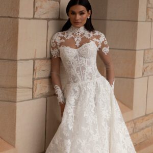 La Premiere Amber Wedding Dress - A-Line style dress featuring a chic cat-eye neckline, drop-waist design, full-cut corded lace and exposed boning.
