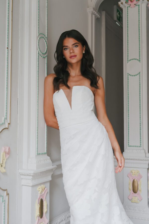 La Premiere Arabella Wedding Dress - A - Line style dress with sweetheart neckline, hand-placed floral appliqués, exposed boning bodice and long sleeves.
