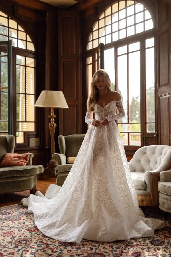 Tina Valerdi Bluebell Wedding Dress - A-line style dress with a sweetheart neckline, off-the-shoulder design, and long, form-fitting sleeves.