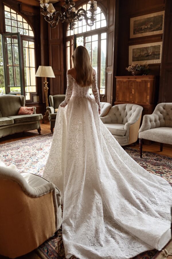 Tina Valerdi Bluebell Wedding Dress - A-line style dress with a sweetheart neckline, off-the-shoulder design, and long, form-fitting sleeves.