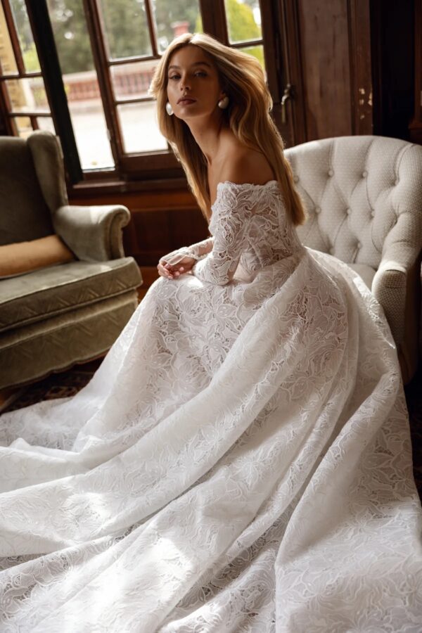 Tina Valerdi Bluebell Wedding Dress - A-line style dress with a sweetheart neckline, off-the-shoulder design, and long, form-fitting sleeves.