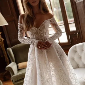 Tina Valerdi Bluebell Wedding Dress - A-line style dress with a sweetheart neckline, off-the-shoulder design, and long, form-fitting sleeves.