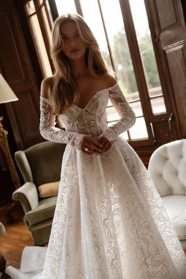 Tina Valerdi Bluebell Wedding Dress - A-line style dress with a sweetheart neckline, off-the-shoulder design, and long, form-fitting sleeves.