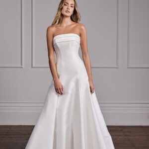 Suzanne Neville Grace Wedding Dress - Classic Modern Bridal Gown with Princess Seams, Straight Strapless Neckline, Corset, Draping Details in Satin Fabric.